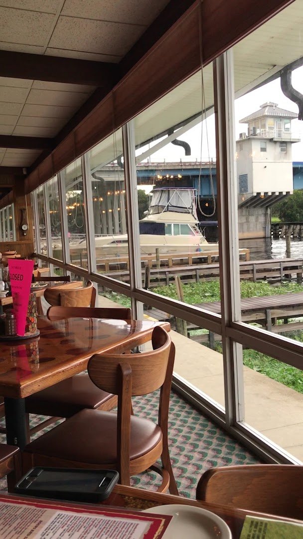 Outdoor seating beside the water at Williams Landing.