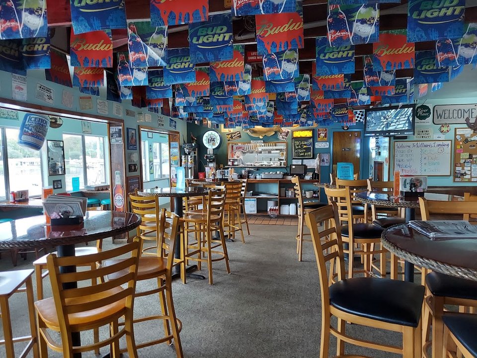 Casual seafood restaurant interior with bar seating.